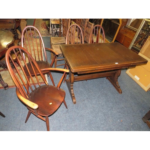 771 - An Ercol dining set comprising an extending table and four chairs