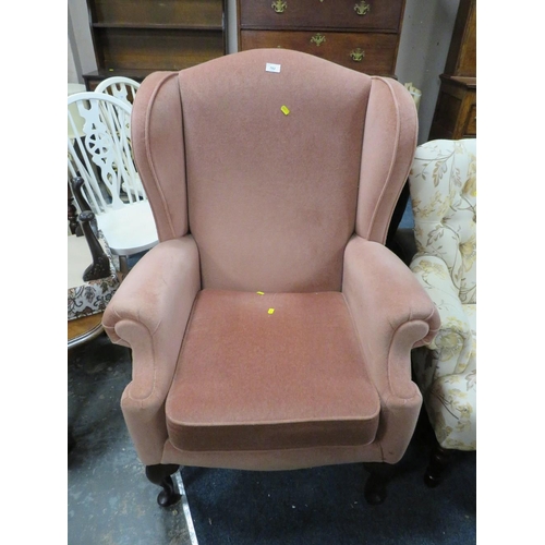 782 - A soft velvet wing backed armchair