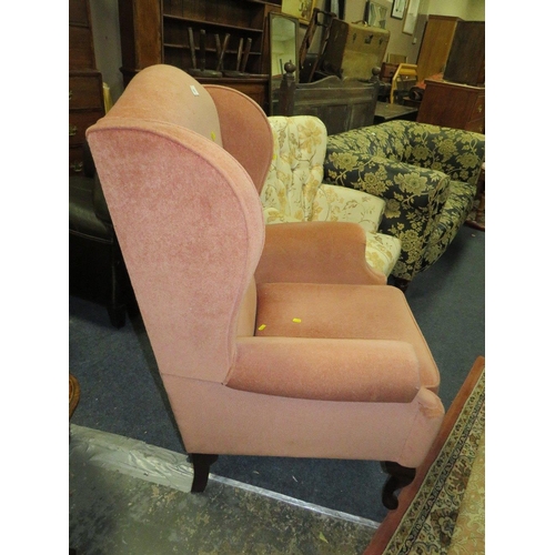 782 - A soft velvet wing backed armchair