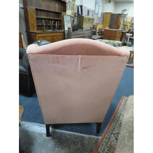 782 - A soft velvet wing backed armchair