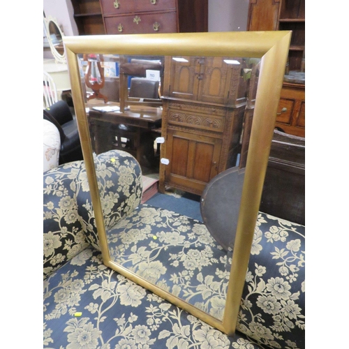 783 - Three wall mirrors to include a modern rectangular framed example and an oval mahogany frame example... 