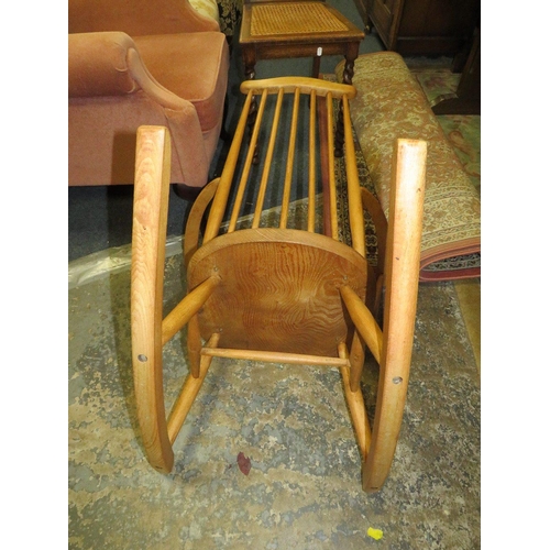 784 - An Ercol blonde oak rocking chair