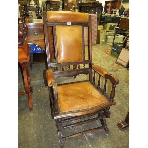 790 - An Edwardian mahogany rocking chair with padded leather panels