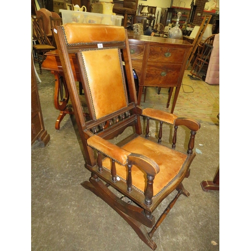 790 - An Edwardian mahogany rocking chair with padded leather panels