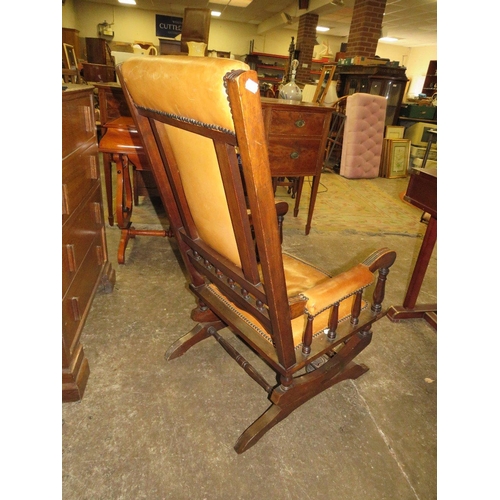 790 - An Edwardian mahogany rocking chair with padded leather panels