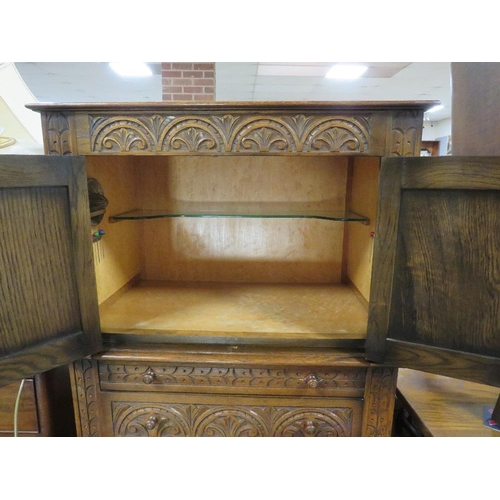 793 - An oak carved drinks cabinet - W 70 cm