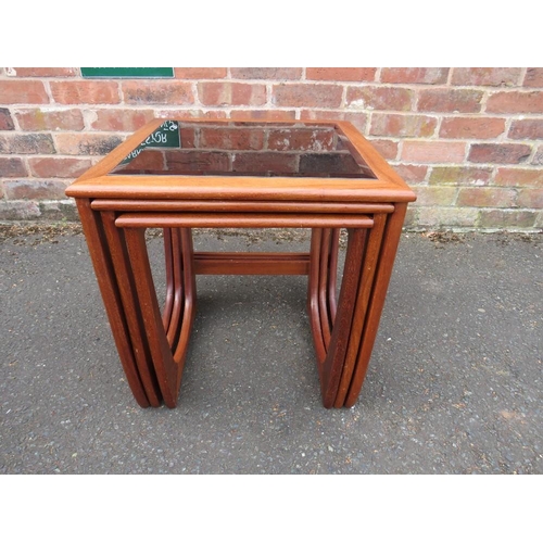 803 - A retro teak nest of three glass topped tables in G-Plan Astro style design