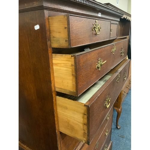 824 - An antique oak tall boy with two short over three long drawers and three further long drawers to the... 