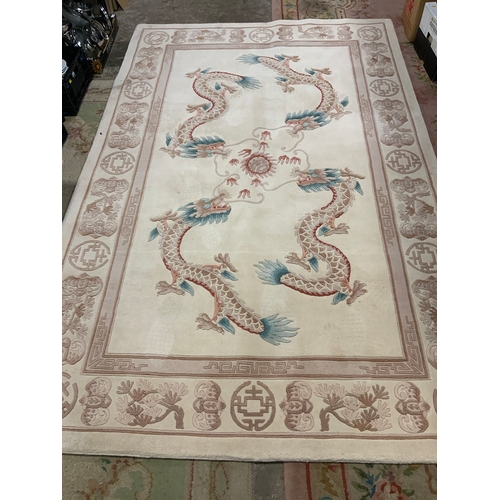 828 - A large modern Chinese woollen dragon rug by GH Frith 274 x 183 cm