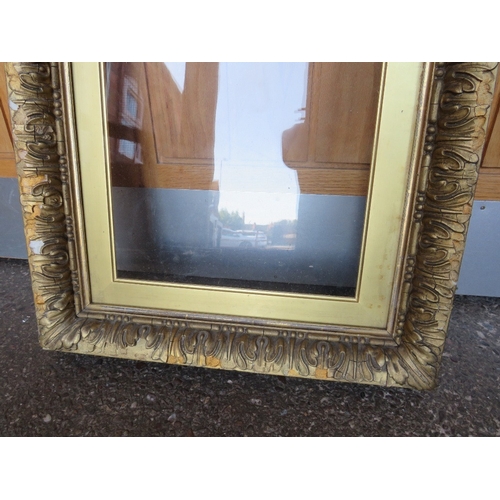 32 - A 19TH CENTURY GOLD FRAME, with gold slip and outer leaf design, glazed, with some restoration, fram... 