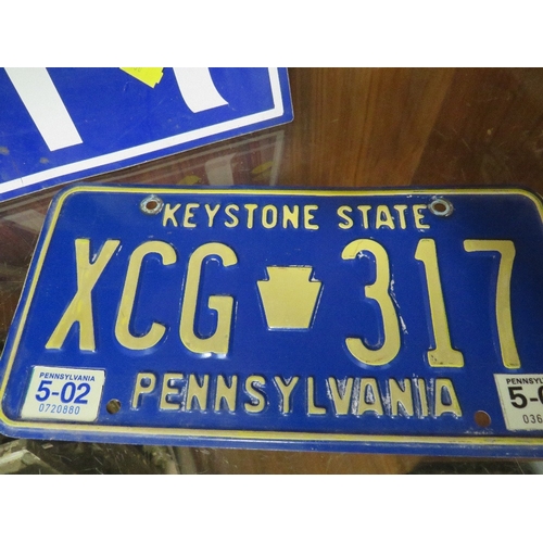 77 - A tray of vintage American license plates to include Florida and Delaware