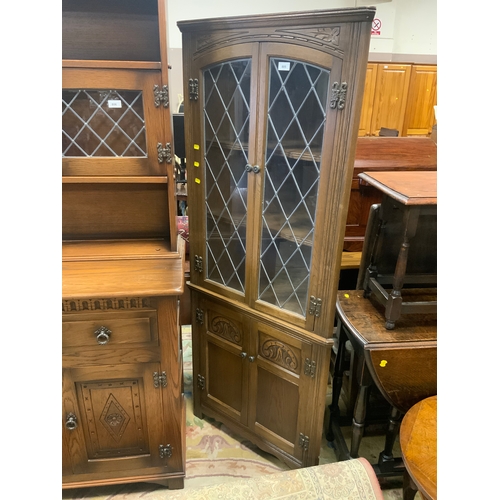 805 - A reproduction oak leaded corner cabinet