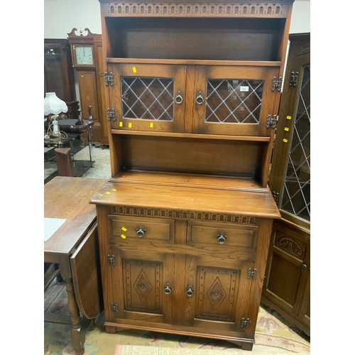 806 - A reproduction oak glazed carved dresser