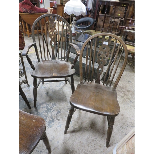 757 - An oak refectory style table together with wheel back chairs