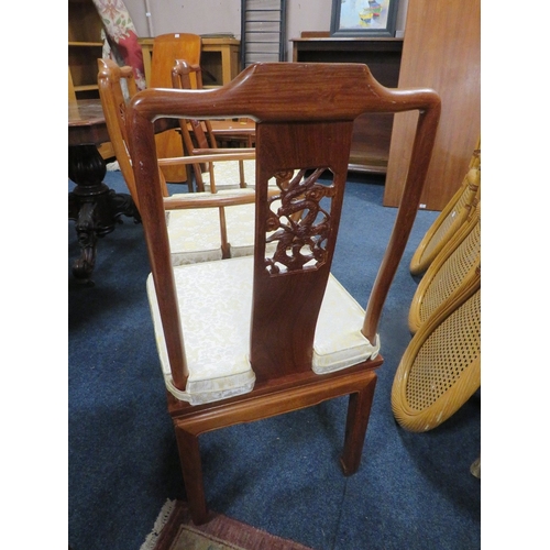 769 - A set of four eastern style hardwood dining chairs