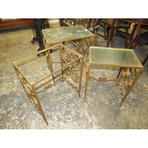 783 - A nest of wrought iron and glass top tables