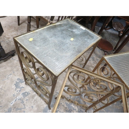 783 - A nest of wrought iron and glass top tables