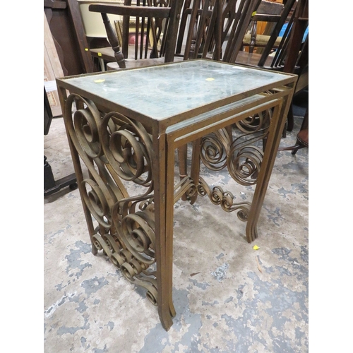 783 - A nest of wrought iron and glass top tables