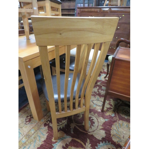 796 - A modern light oak extending dining table and six chairs