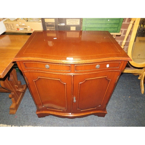 736 - A reproduction serpentine shaped mahogany cabinet W 74 cm