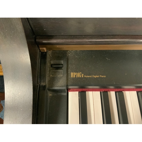 742 - A Roland HP107e electric keyboard with stool - House clearance