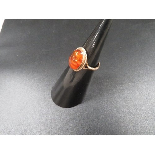 328 - A hallmarked 9ct gold ring set with amber approx. weight 2g