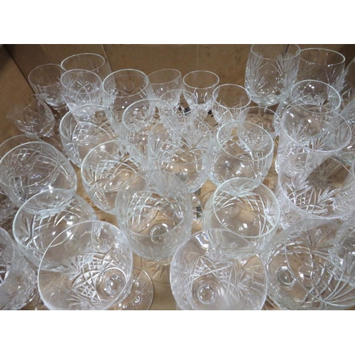 103 - A large quantity of cut glass and crystal over several trays to include wine glasses, brandy glasses... 