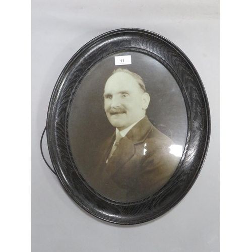 11 - A pair of oval oak framed photographs