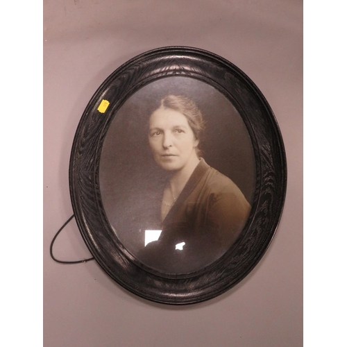 11 - A pair of oval oak framed photographs