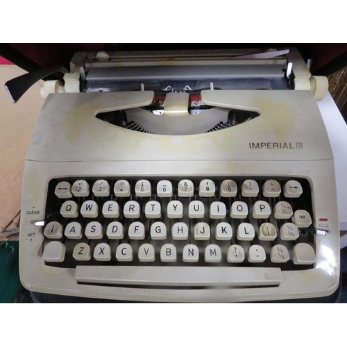 114 - A modern red anglepoise style desk lamp together with two cased typewriters etc