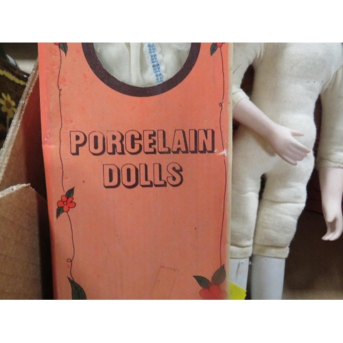 123 - A tray of porcelain dolls in original boxes