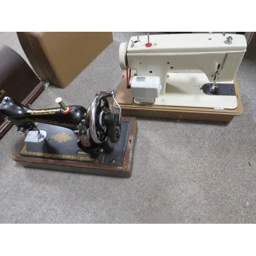 135 - A cased Singer sewing machine together with a cased Winfield example