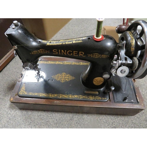 135 - A cased Singer sewing machine together with a cased Winfield example