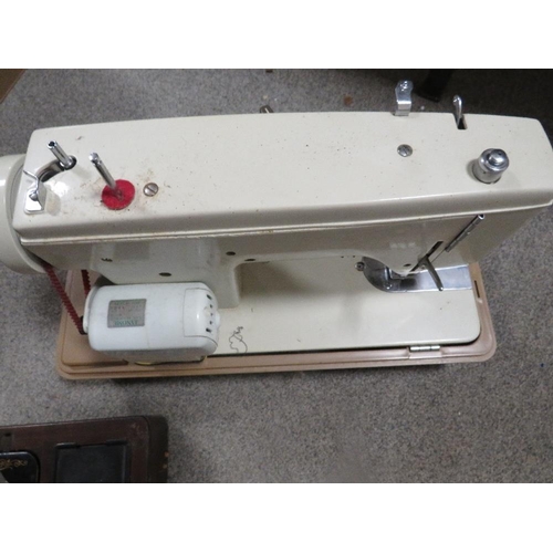 135 - A cased Singer sewing machine together with a cased Winfield example