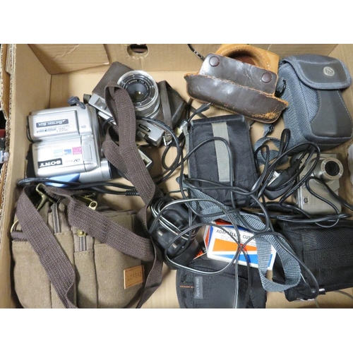 142 - Three trays of cameras, equipment and accessories to include Nikon