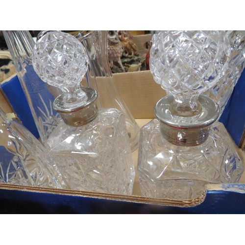 57 - A tray of assorted cut glass to include decanters