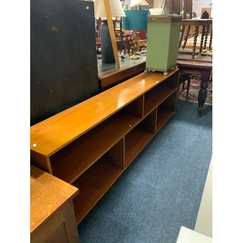 763 - A large low open mid century teak open bookcase L 214 cm together with a linen box. (2)