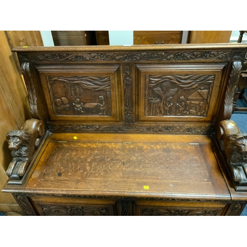 766 - A heavy carved oak monks bench W 121 cm