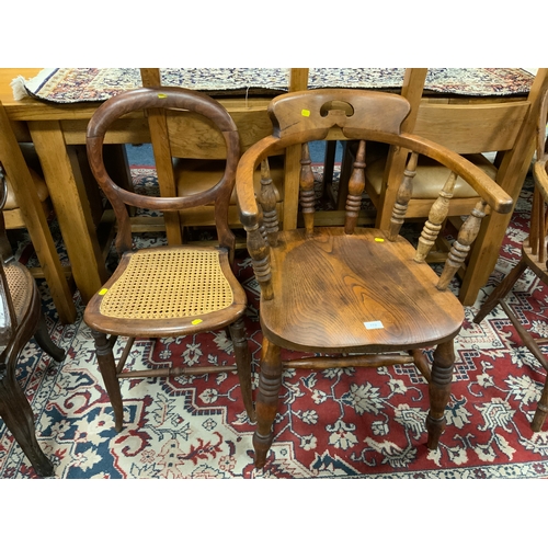 772 - A traditional Elm smokers bow armchair together with an antique bergere bedroom chair. (2)