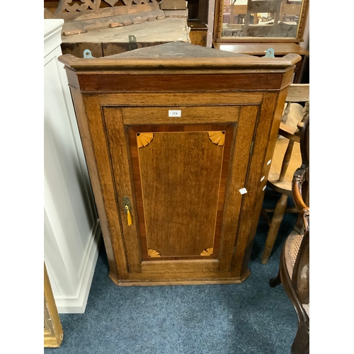 774 - A Georgian oak and mahogany hanging corner cupboard