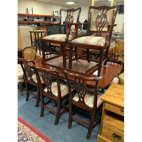 783 - A reproduction mahogany extending twin pedestal dining table and eight chairs