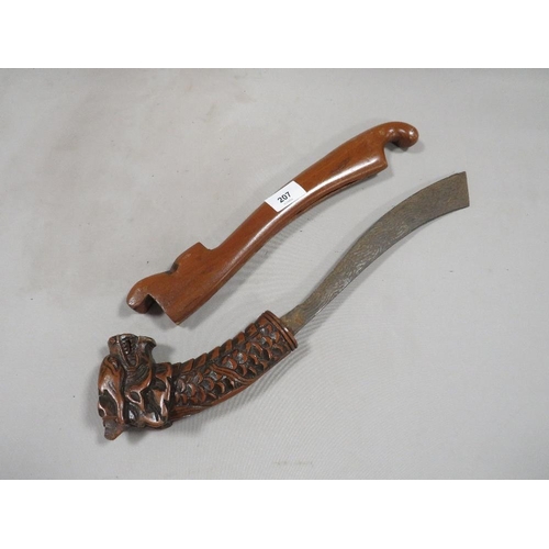 207 - A vintage Far Eastern dagger with wooden scabbard and carved dragons head to handle