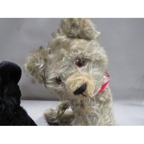 243 - A vintage teddy bear together with a modern Scottie toy dog