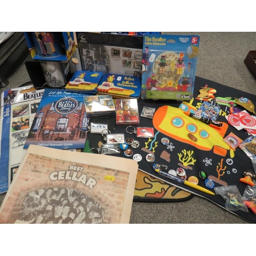 263 - A collection of assorted modern Beatles memorabilia, to include a collection of badges, KNex figures... 