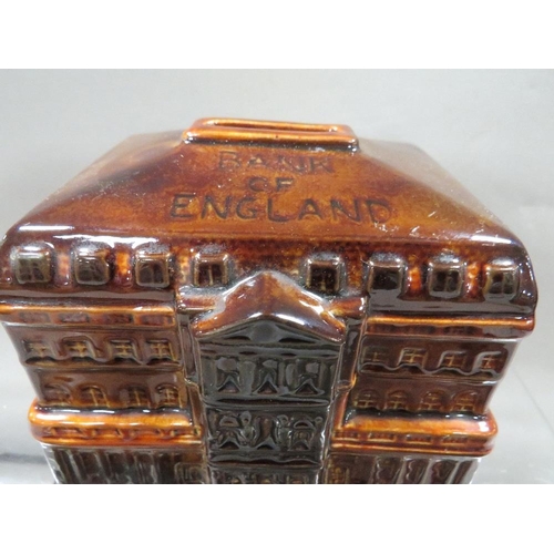 264 - A vintage Birmingham Municipal bank metal money box together with a treacle glaze Bank Of England mo... 