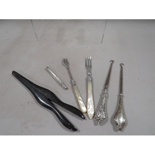 290 - A small bag of silver and other collectables to include a pair of ebonised glove stretchers, a hallm... 