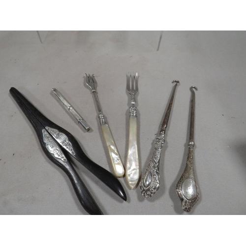 290 - A small bag of silver and other collectables to include a pair of ebonised glove stretchers, a hallm... 