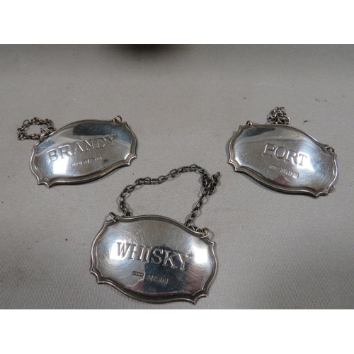 291 - A cased presentation set of hallmarked silver decanter labels consisting of Brandy, Whisky, Port, Sh... 