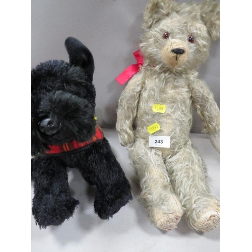 243 - A vintage teddy bear together with a modern Scottie toy dog