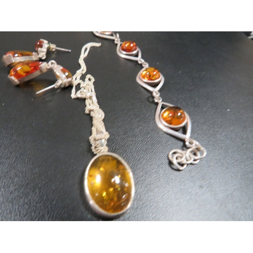 354 - An amber and sterling silver bracelet, pendant on chain and earrings